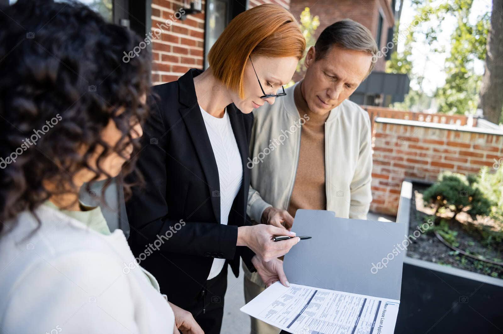 redhead realtor holding pen folder